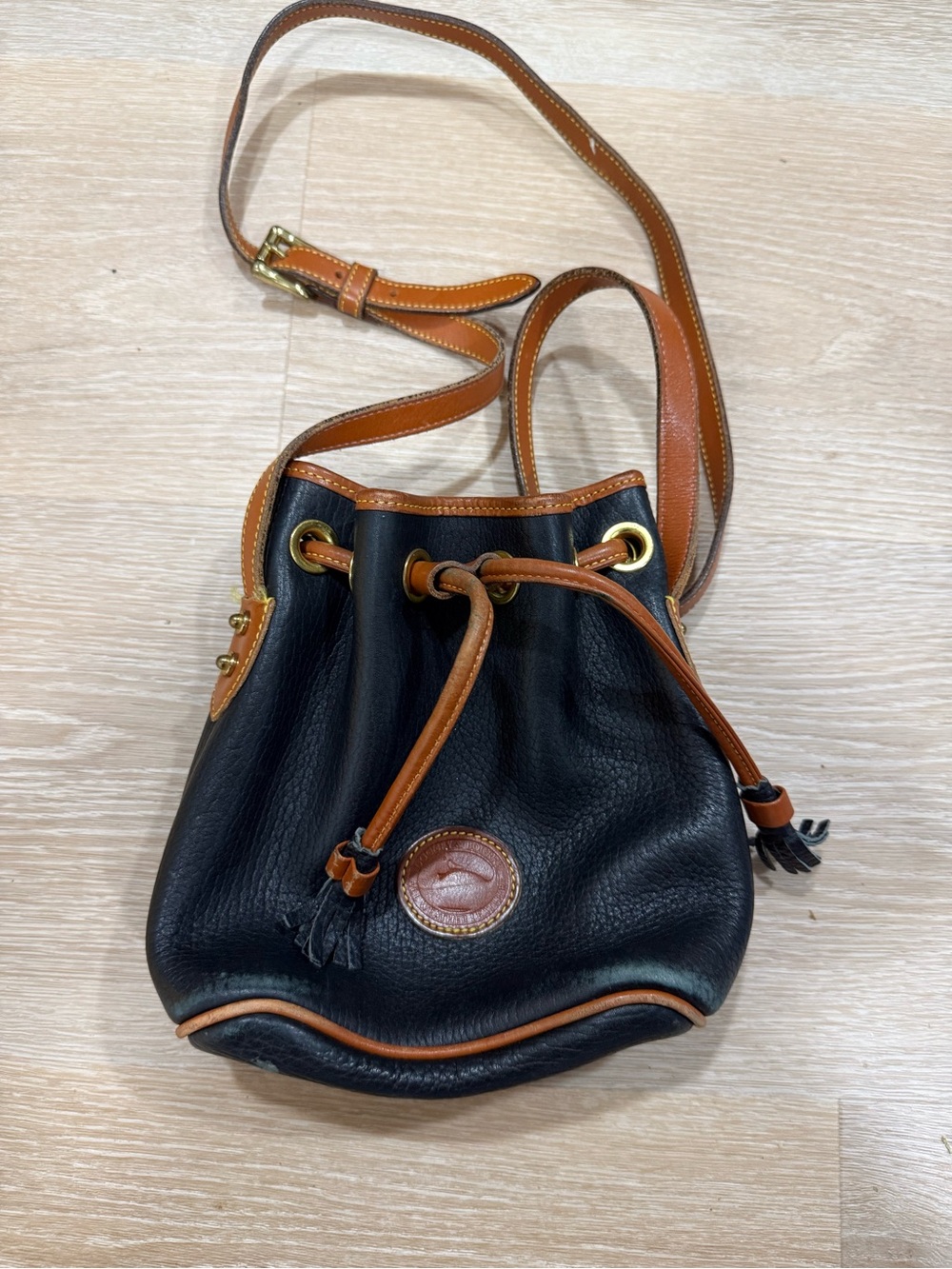 Dooney & Bourke Vintage Black Leather Drawstring Crossbody with Brown Trim